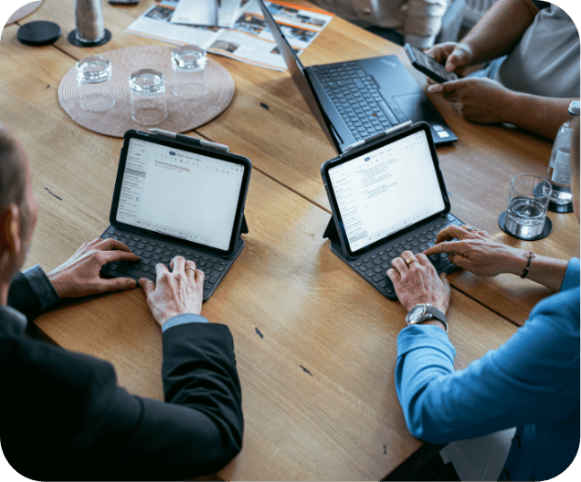 Zwei Personen arbeiten während einer Besprechung an Tablets zusammen und präsentieren moderne Karrieremöglichkeiten am Arbeitsplatz.
