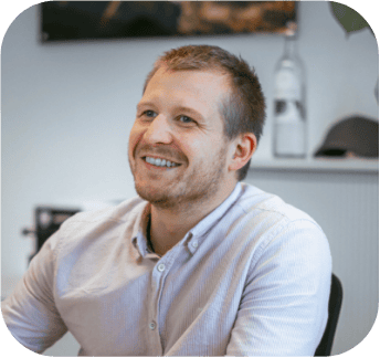 Lächelnder Mann in einem hellrosa Hemd