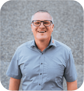 Glücklicher Mann mit Brille und grauem Hemd